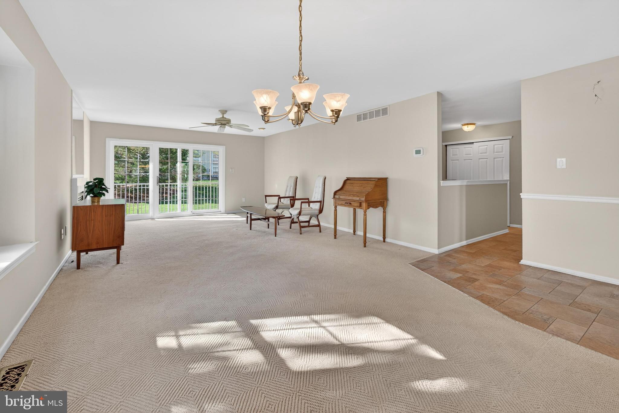 7401A Normandy Drive Mount Laurel, NJ 08054 - Photo 9 of 35 a view of a livingroom with furniture a chandelier and window