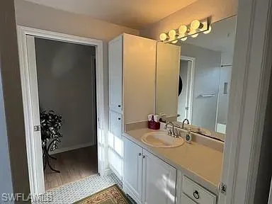 a bathroom with a double vanity sink a mirror and a shower