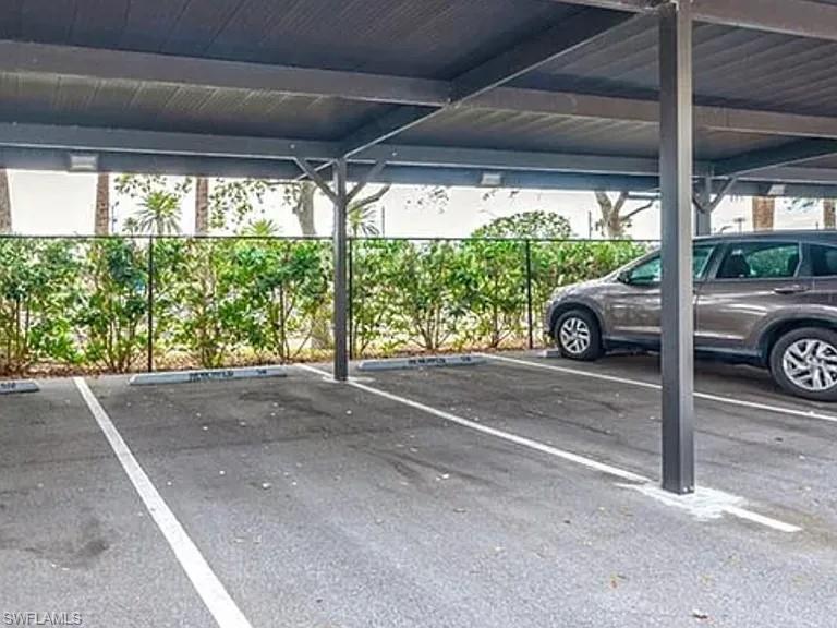 7905 Preserve Circle, Unit 138 Naples, FL 34119 - Photo 16 of 27 a car parked in front of a house
