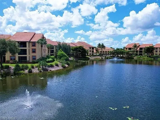 a view of a lake with a house in the background
