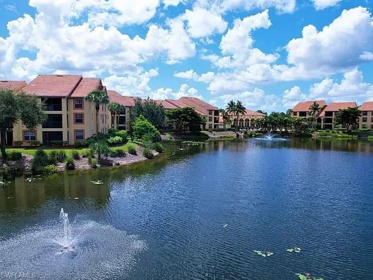 7905 Preserve Circle, Unit 138 Naples, FL 34119 - Photo 20 of 27 a view of a lake with a house in the background