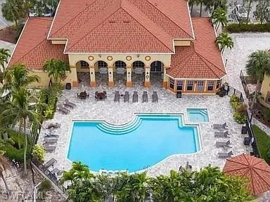 an aerial view of house with swimming pool and yard