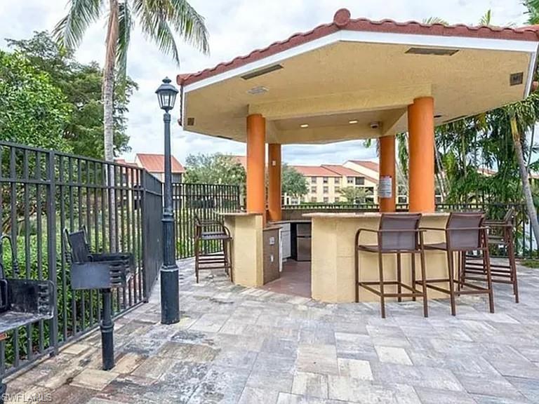7905 Preserve Circle, Unit 138 Naples, FL 34119 - Photo 21 of 27 a backyard of a house with sofas table and chairs