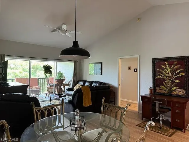 a living room with furniture a window and a chandelier