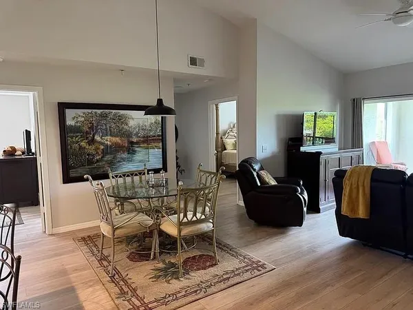 a living room with furniture a window and a flat screen tv