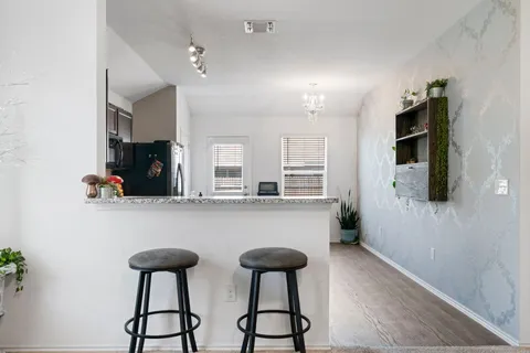 a kitchen with stainless steel appliances granite countertop a refrigerator a sink and a stove