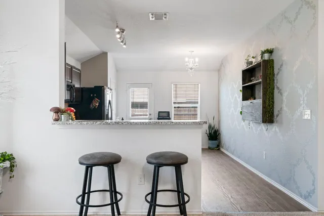 a kitchen with stainless steel appliances granite countertop a refrigerator a sink and a stove