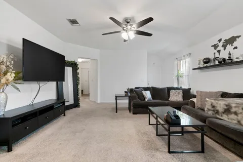 a living room with furniture and a flat screen tv