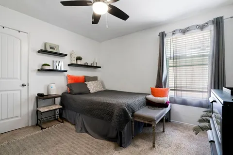 a bedroom with furniture and a window