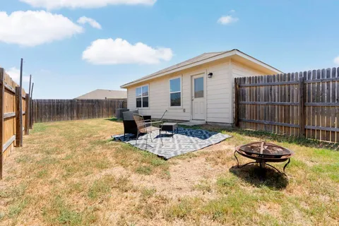 a view of a house with swimming pool and sitting area