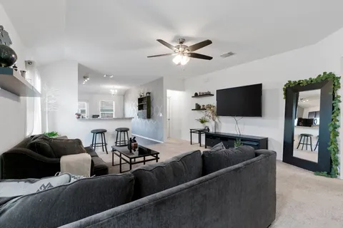 a living room with furniture and a flat screen tv
