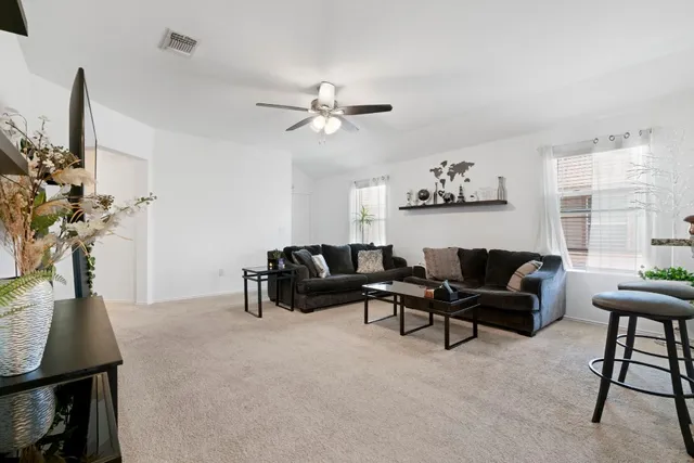 a living room with furniture a chandelier and a window