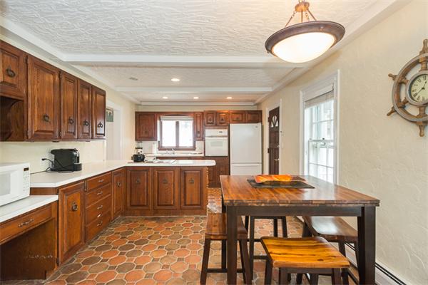 40 Hutchinson Road Arlington, MA 02474 - Photo 12 of 23 a kitchen with stainless steel appliances granite countertop a stove top oven a sink dishwasher and cabinets with wooden floor