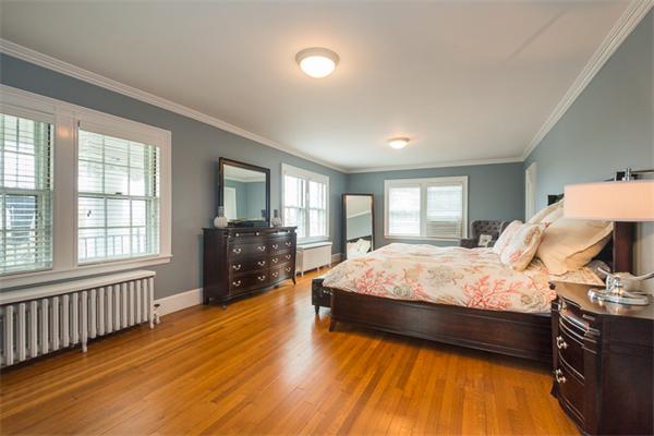 40 Hutchinson Road Arlington, MA 02474 - Photo 15 of 23 a bedroom with a bed and wooden floor