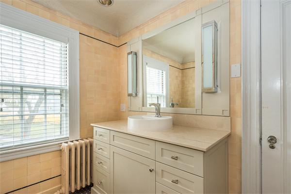 40 Hutchinson Road Arlington, MA 02474 - Photo 17 of 23 a bathroom with a granite countertop sink and a mirror