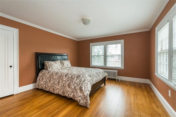 40 Hutchinson Road Arlington, MA 02474 - Photo 18 of 23 a bedroom with a bed and wooden floor