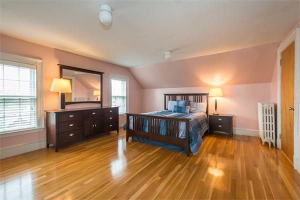 40 Hutchinson Road Arlington, MA 02474 - Photo 20 of 23 a bedroom with a bed and wooden floor