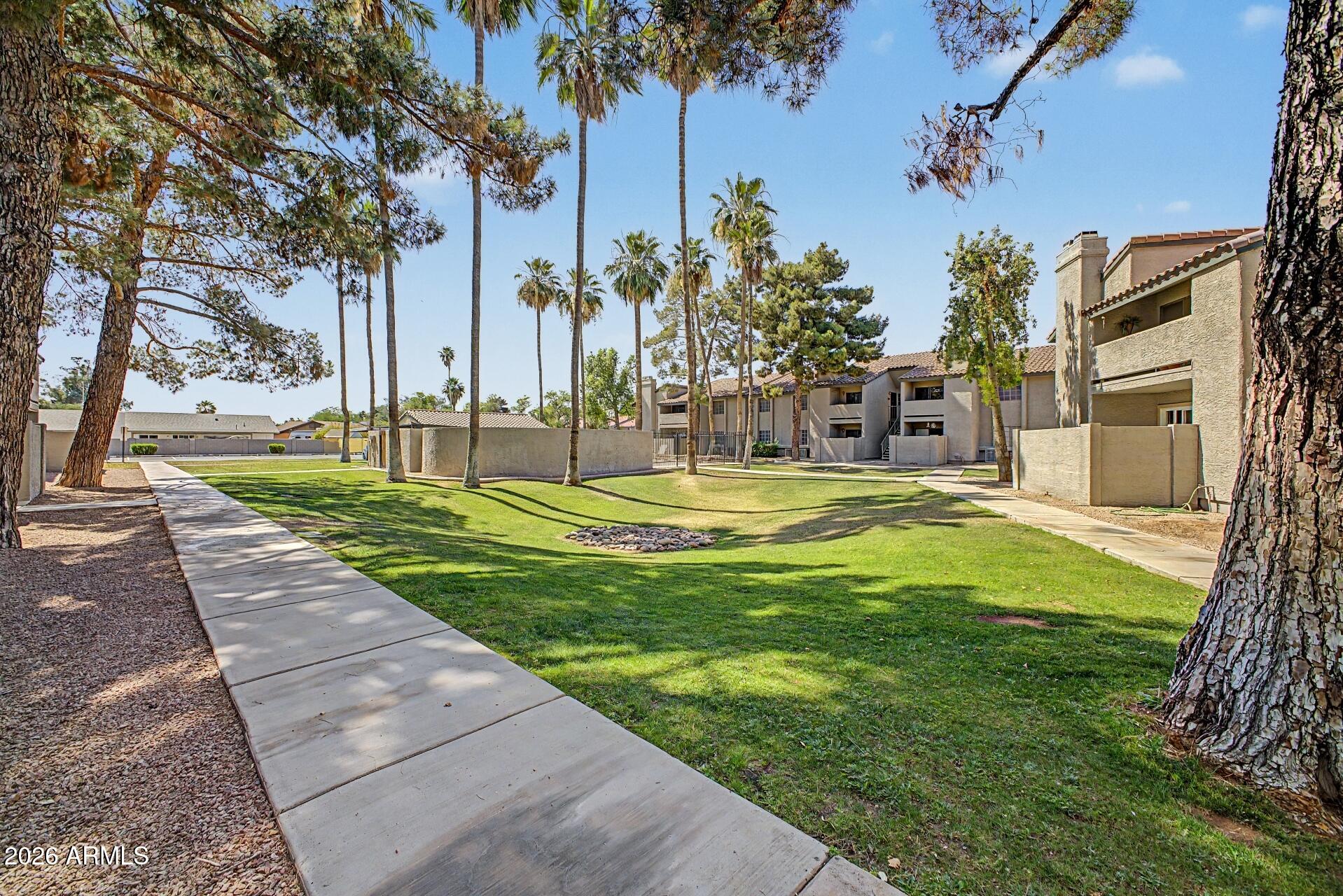 533 West Guadalupe Road, Unit 1104 Mesa, AZ 85210 - Photo 17 of 20 a swimming pool with outdoor seating and yard