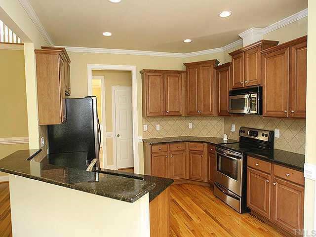 2800 Candlehurst Lane Raleigh, NC 27616 - Photo 4 of 9 a kitchen with stainless steel appliances granite countertop a stove a sink and a refrigerator