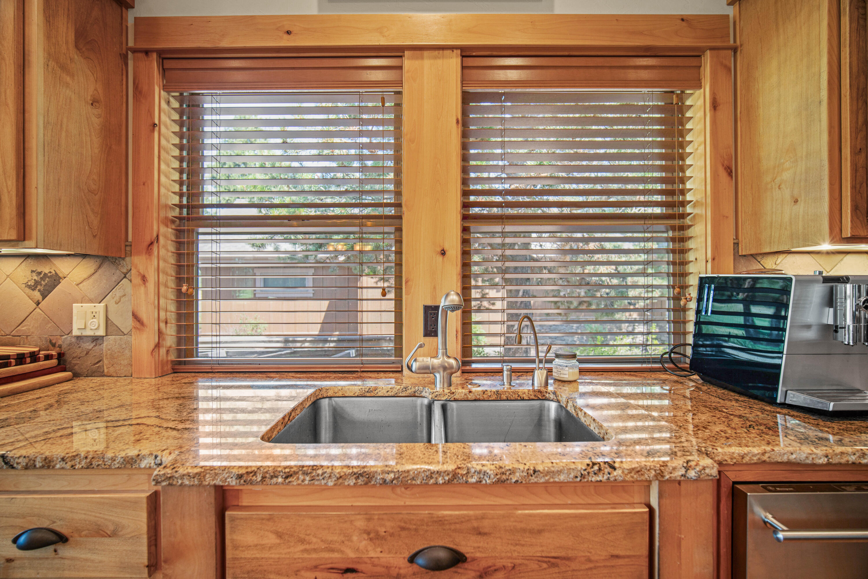 56689 Dancing Rock Loop Bend, OR 97707 - Photo 15 of 51 a kitchen with stainless steel appliances granite countertop a sink and a window