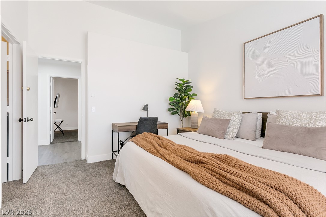 101 Beaver Ridge Avenue North Las Vegas, NV 89031 - Photo 14 of 42 A quiet bedroom retreat with plush carpeting and a dedicated workspace awaits.