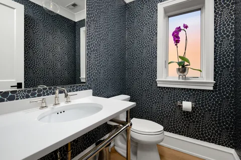 a bathroom with a sink mirror and toilet