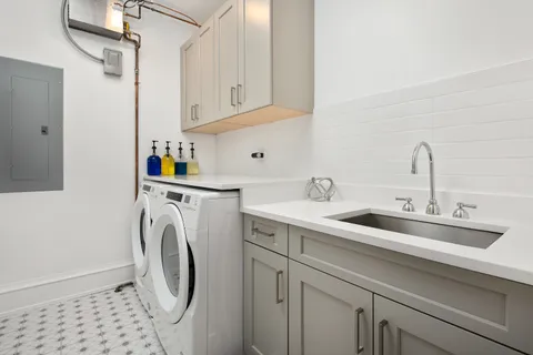 a utility room with sink dryer and washer