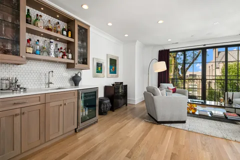 a living room with furniture and a floor to ceiling window