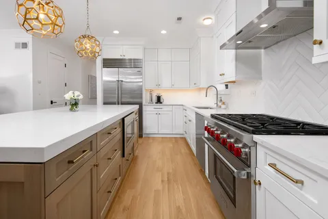 a kitchen with cabinets and wooden floor