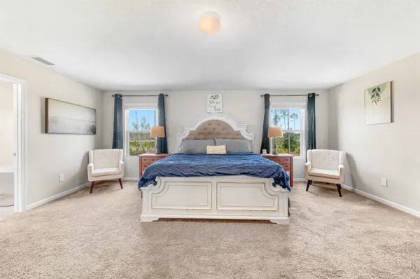 a spacious bedroom with a bed and a couch