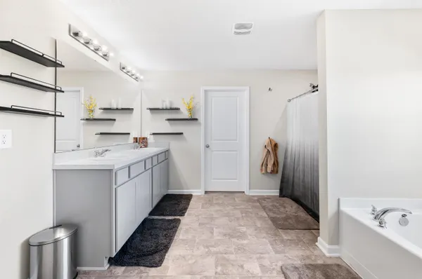 a kitchen with a sink refrigerator and cabinets