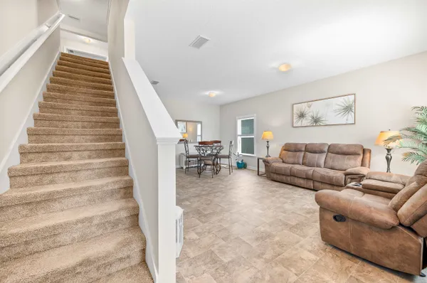 a living room with furniture and a stair