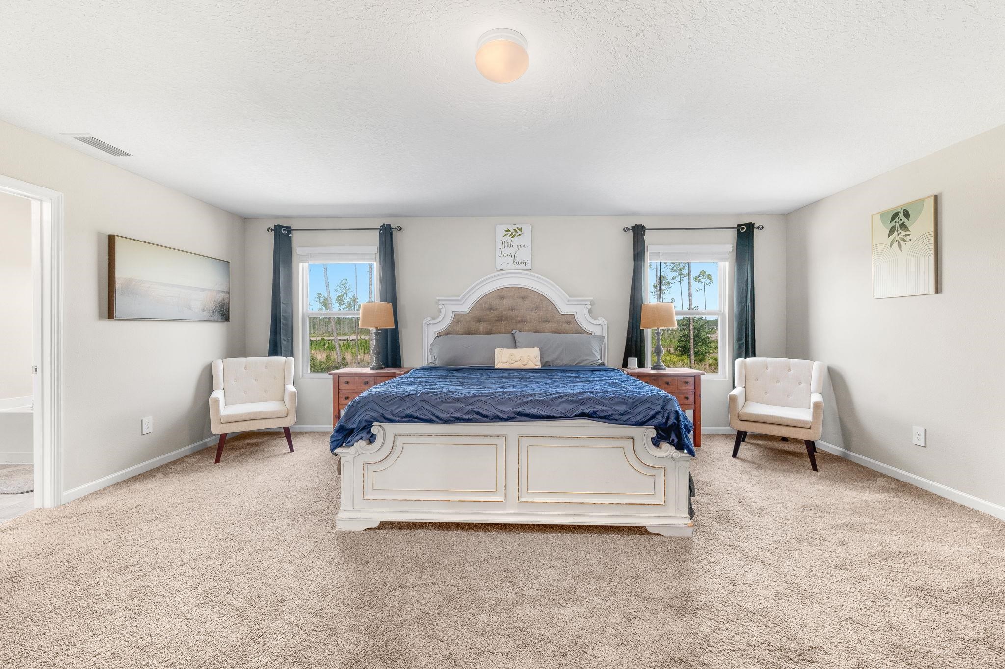 71 Barbosa Trail St. Augustine, FL 32095 - Photo 33 of 51 a spacious bedroom with a bed and a couch