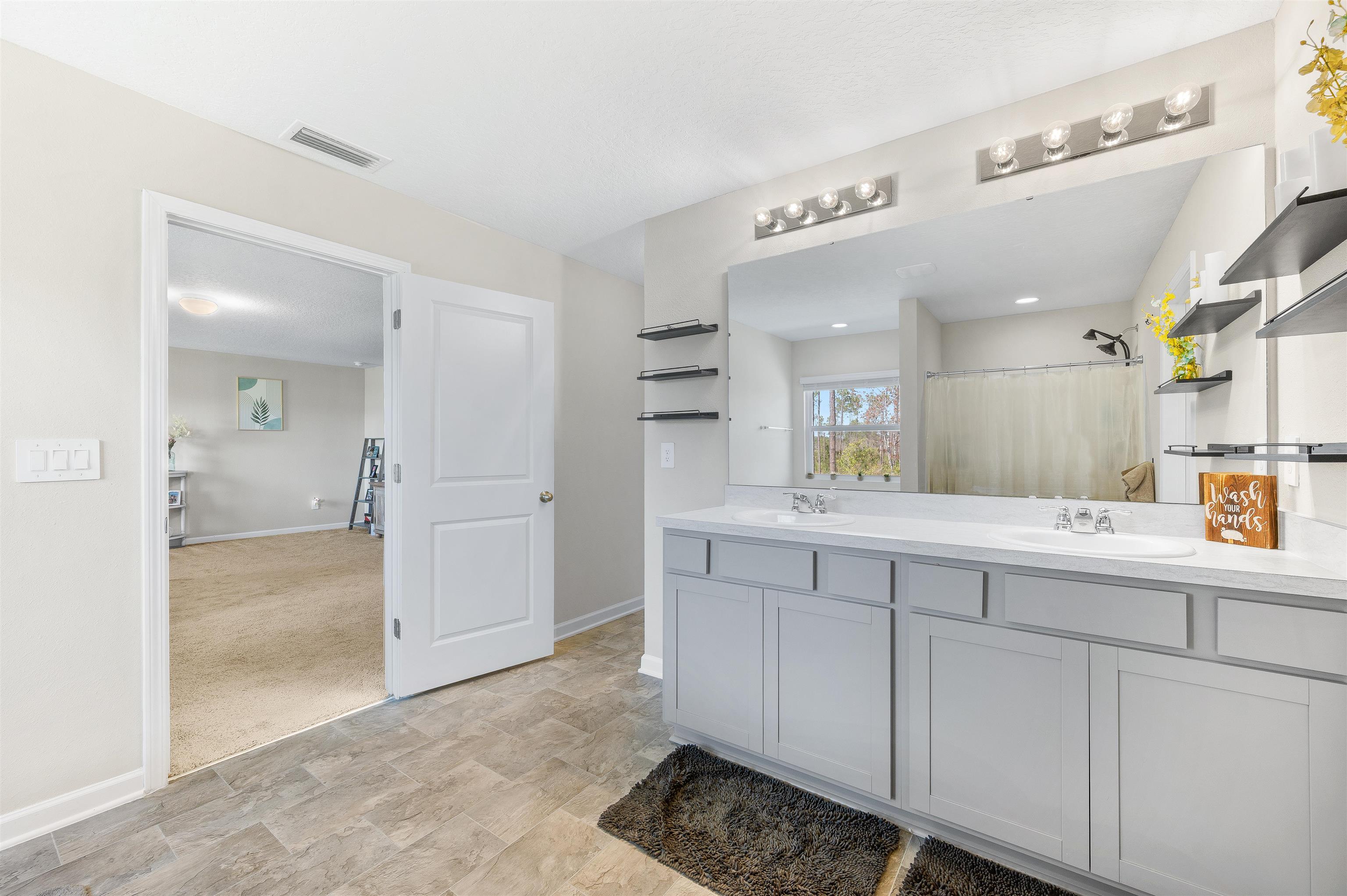 71 Barbosa Trail St. Augustine, FL 32095 - Photo 34 of 51 a bathroom with a sink and a mirror