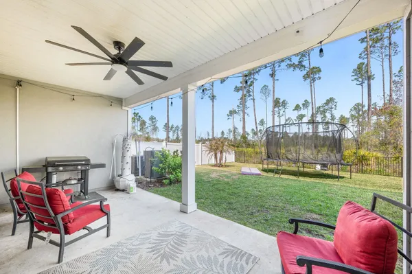 a swimming pool with outdoor seating and yard