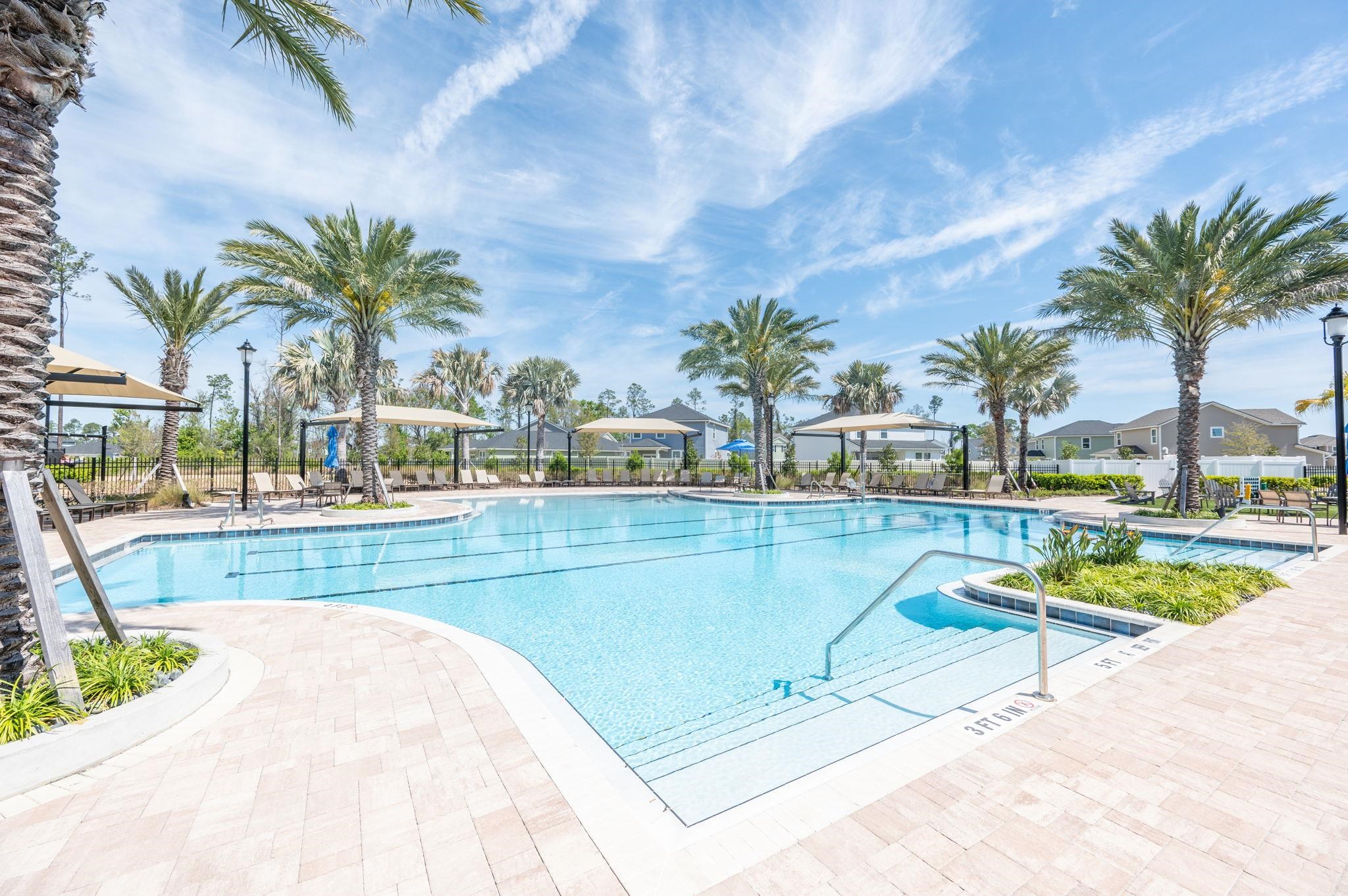 71 Barbosa Trail St. Augustine, FL 32095 - Photo 46 of 51 a view of swimming pool with outdoor seating and house in the background