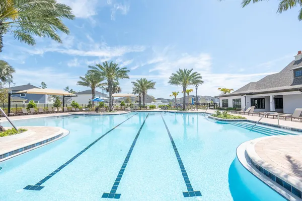 a view of swimming pool with outdoor seating and plants