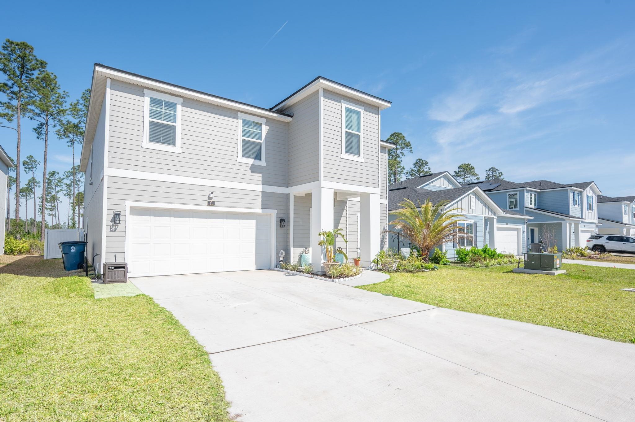 71 Barbosa Trail St. Augustine, FL 32095 - Photo 51 of 51 a front view of a house with a yard and garage