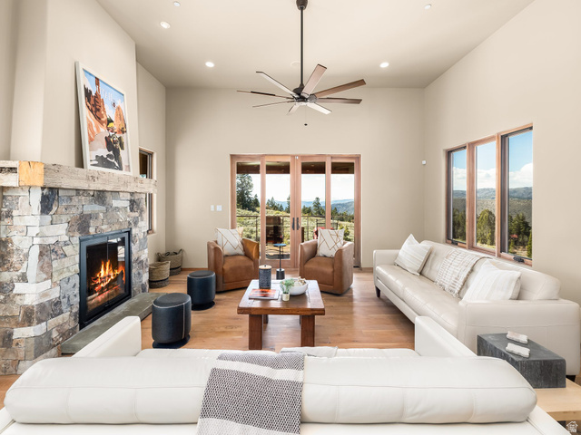 22677 East Snowbird Drive, Unit 47 Helper, UT 84526 - Photo 8 of 43 Living area featuring wood finished floors, a stone fireplace, recessed lighting, a high ceiling, and a ceiling fan