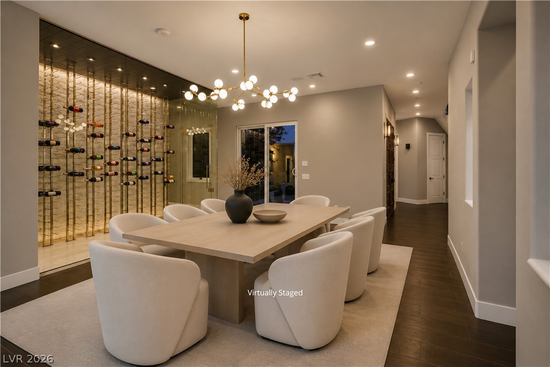 6 Rue Du Ville Henderson, NV 89011 - Photo 9 of 99 “Virtually Staged” This elegant dining space features a striking wine display and seamless indoor-outdoor living.
