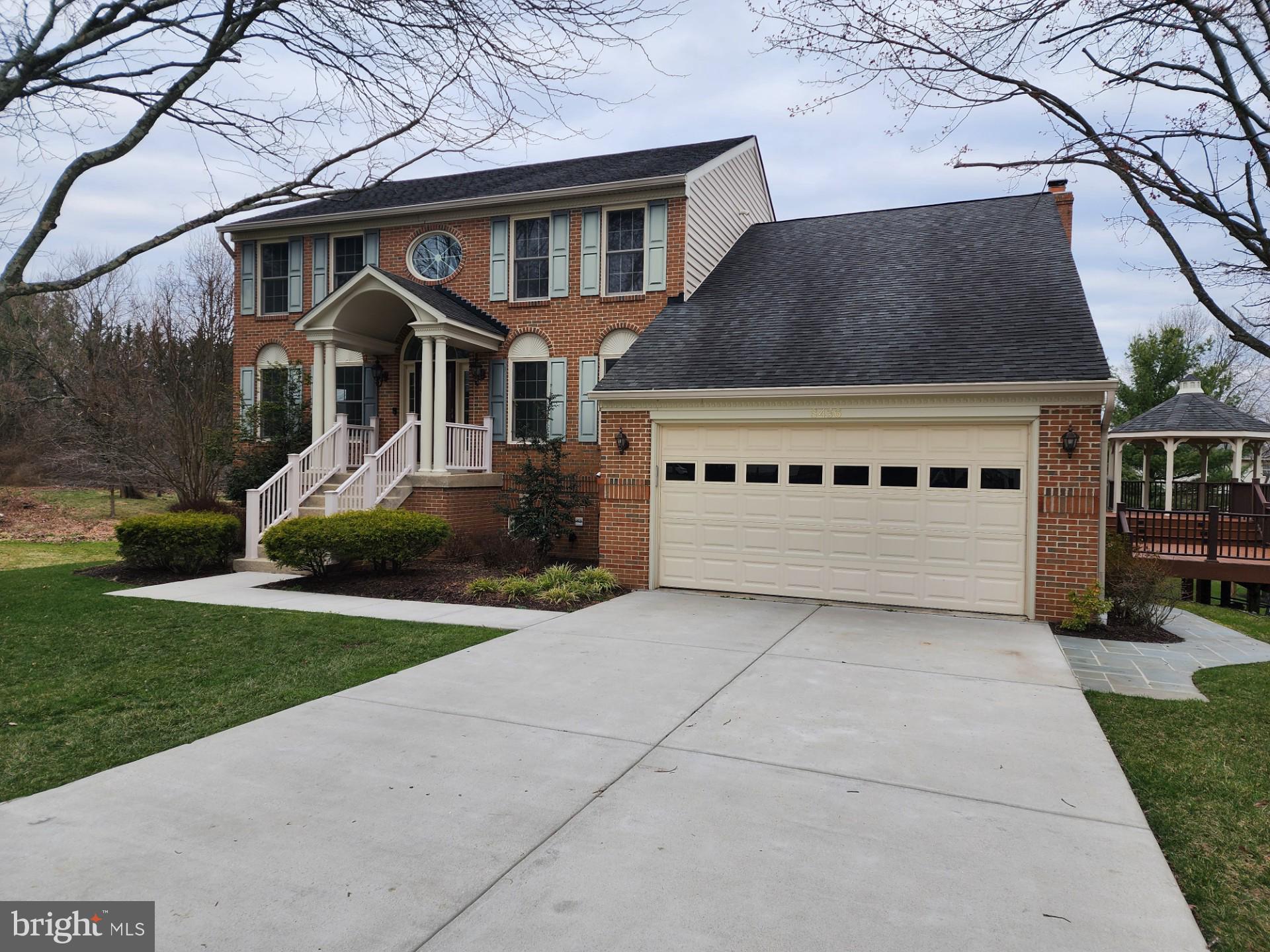 8456 Roberts Road Ellicott City, MD 21043 - Photo 1 of 4 a front view of a house with a yard and garage