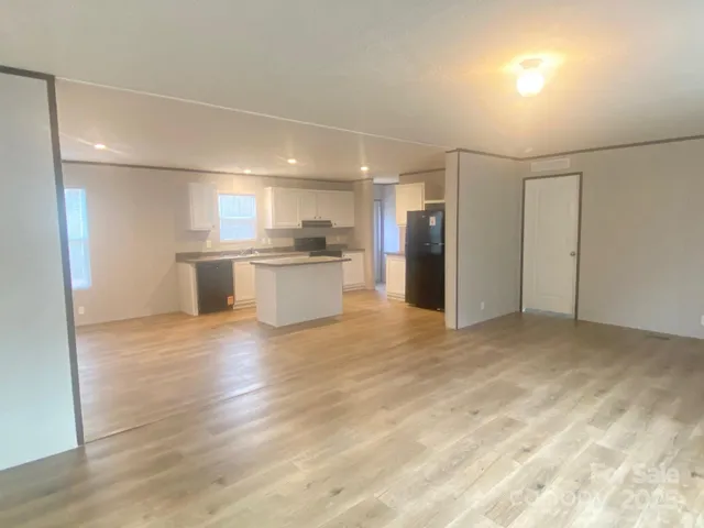a view of a kitchen with a sink and a refrigerator