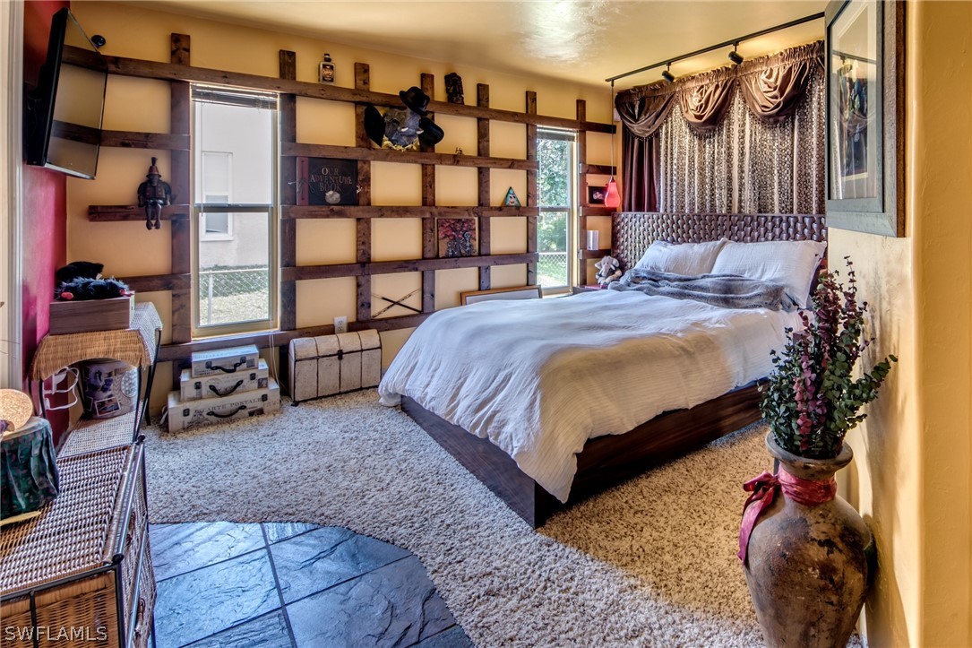 9056 Aster Road Fort Myers, FL 33967 - Photo 2 of 6 a bedroom with a bed and a window