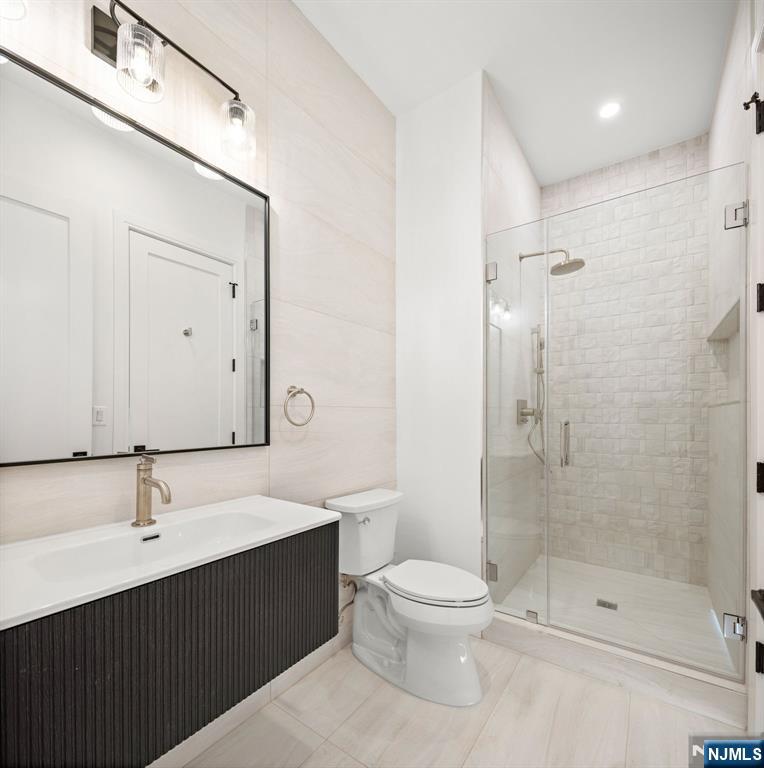 375 Burnet Place Paramus, NJ 07652 - Photo 12 of 37 a bathroom with a shower sink vanity and toilet