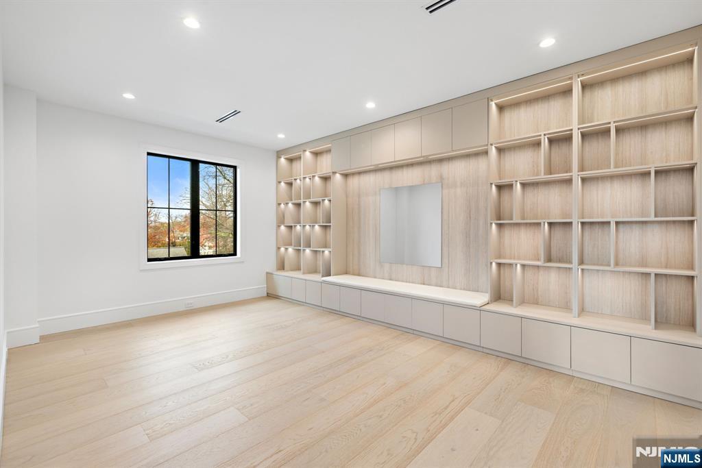 375 Burnet Place Paramus, NJ 07652 - Photo 14 of 37 an empty room with cabinet and windows