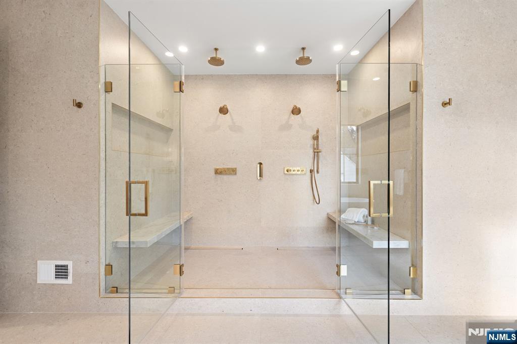 375 Burnet Place Paramus, NJ 07652 - Photo 19 of 37 a bathroom with a glass shower door