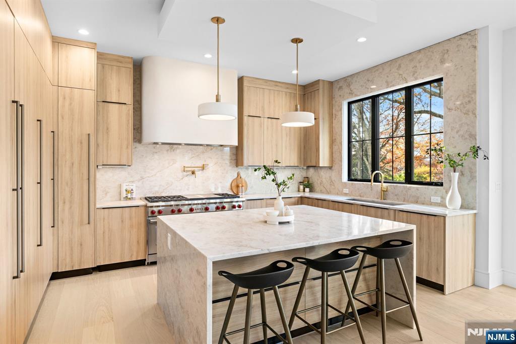 375 Burnet Place Paramus, NJ 07652 - Photo 3 of 37 a kitchen with stainless steel appliances granite countertop a stove a refrigerator a sink a dining table and chairs
