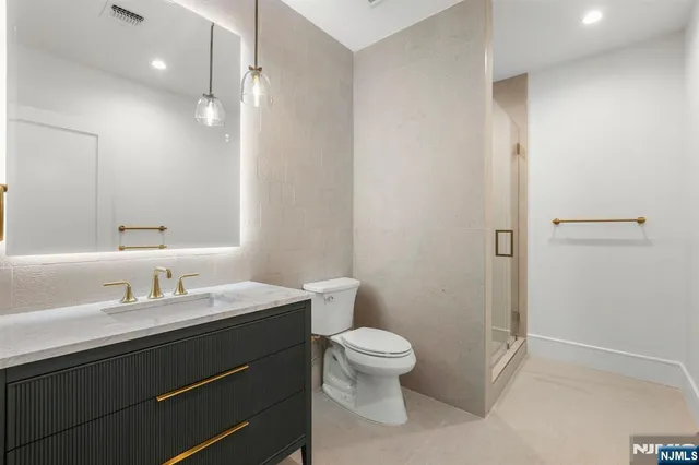 a view of a wooden bench next to a building