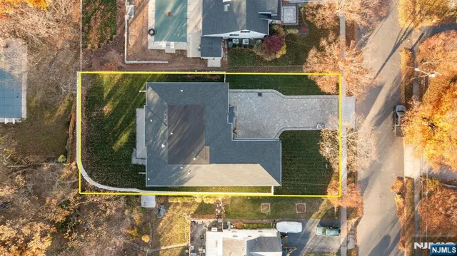 a front view of a house with a garden and yard