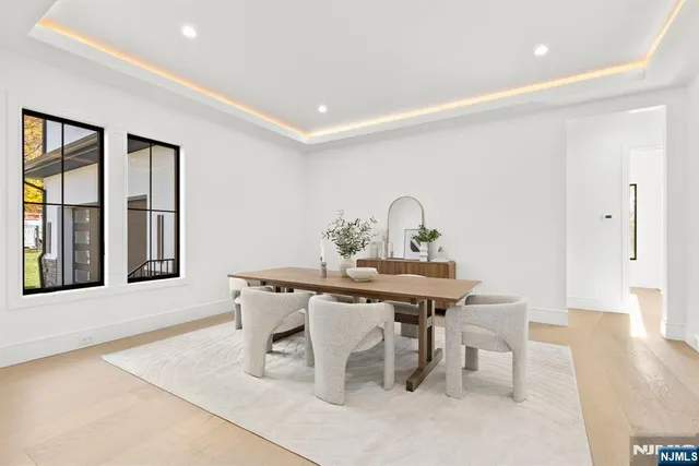 a kitchen with granite countertop white cabinets and window